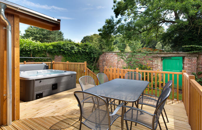 Decking area with outside furniture and outdoor hot tub