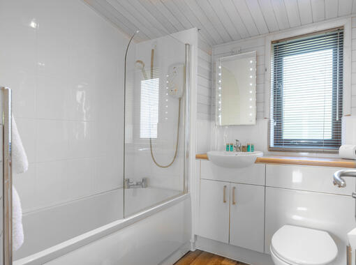 Family bathroom with shower over bath