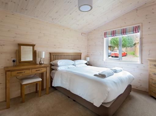 Comfortable double bedroom with dressing table to the side