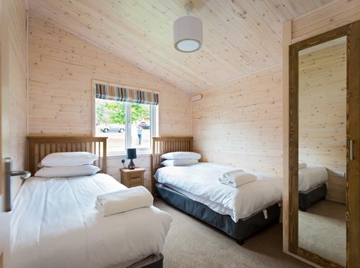 Comfortable twin bedroom with built in wardrobe with mirrored doors